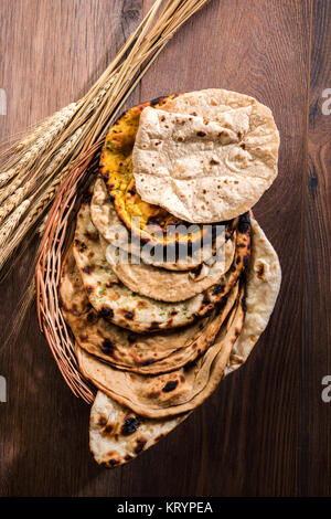 Assorted Indian Bread Basket includes chapati, tandoori roti or naan, paratha, kulcha, fulka, missi roti Stock Photo