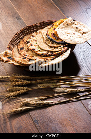 Assorted Indian Bread Basket includes chapati, tandoori roti or naan, paratha, kulcha, fulka, missi roti Stock Photo