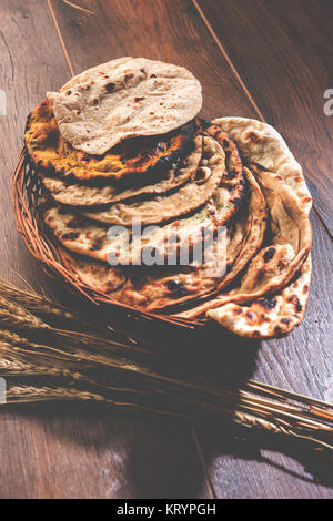 Assorted Indian Bread Basket includes chapati, tandoori roti or naan, paratha, kulcha, fulka, missi roti Stock Photo