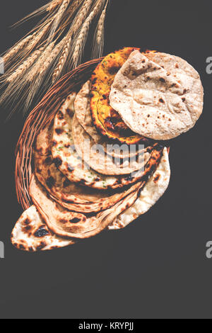 Assorted Indian Bread Basket includes chapati, tandoori roti or naan, paratha, kulcha, fulka, missi roti Stock Photo