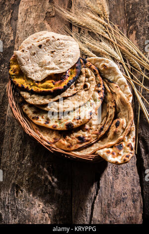 Assorted Indian Bread Basket includes chapati, tandoori roti or naan, paratha, kulcha, fulka, missi roti Stock Photo