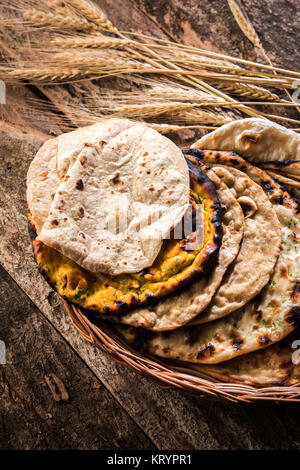 Assorted Indian Bread Basket includes chapati, tandoori roti or naan, paratha, kulcha, fulka, missi roti Stock Photo