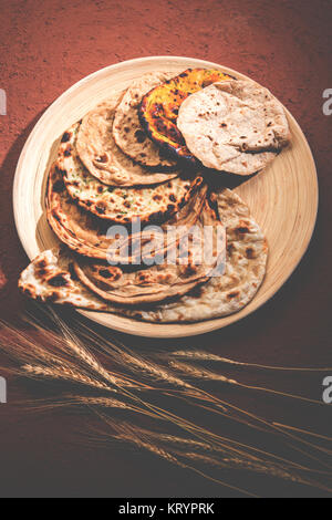 Assorted Indian Bread Basket includes chapati, tandoori roti or naan, paratha, kulcha, fulka, missi roti Stock Photo