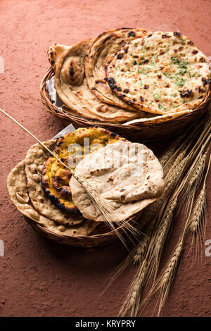 Assorted Indian Bread Basket includes chapati, tandoori roti or naan, paratha, kulcha, fulka, missi roti Stock Photo