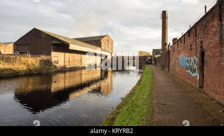 Liverpool, England, UK - November 12, 2016: Run down and derelict industrial warehouses and factory buildings stand beside the Leeds and Liverpool Can Stock Photo