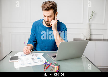 UX designer working on the mobile application experience sketching drawings at the office Stock Photo