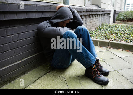 Worried Man Sitting Alone Stock Photo