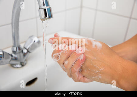 Woman Applying Soap On The Hand Near Basin Stock Photo