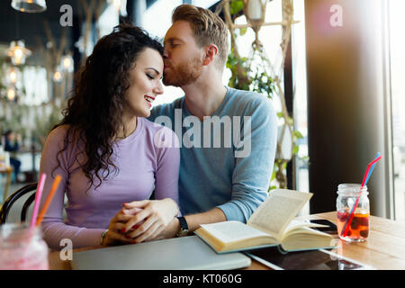 Young happy couple on date in coffee shop