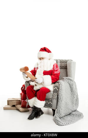 Santa Claus reading Christmas wishlist Stock Photo