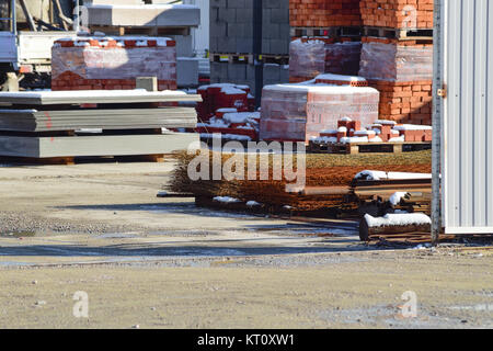 Warehouse of different materials. Wood and iron pipes and bricks Stock Photo