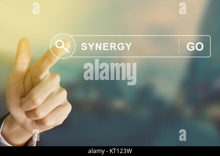 business hand clicking synergy button on search toolbar Stock Photo