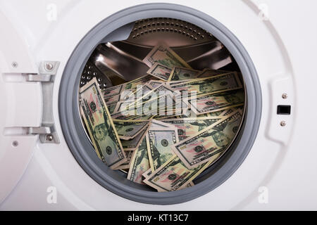 Pile Of Money In Washing Machine Stock Photo