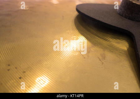 Metallic drum plate in white room Stock Photo