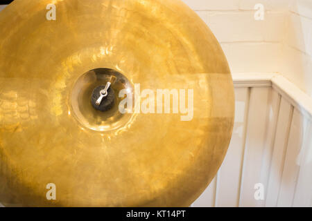 Metallic drum plate in white room Stock Photo