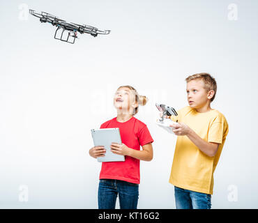 Kids using digital tablet and hexacopter drone Stock Photo