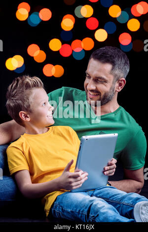 Father and son using digital tablet Stock Photo