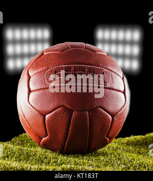 Old football over green grass Stock Photo