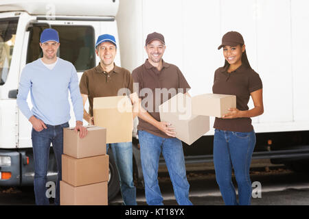 Group of delivery people with boxes Stock Photo