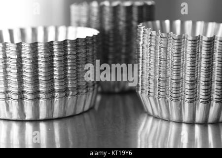 Stack of stainless steel pastry moulds Stock Photo