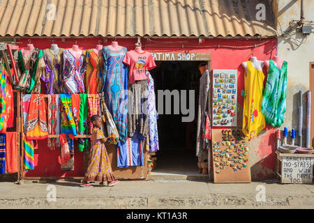 Local girl walking past a souvenir clothing shop Santa Maria Sal