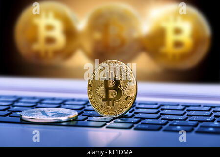 Blue close up golden bitcoin coin crypto Currency background concept. Golden bitcoin coin on the black laptop keyboard. Macro. Blue colored Stock Photo