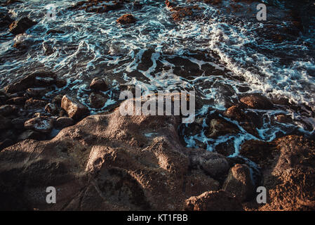 View of ocean waves and fantastic rocky coast with beautiful shaped coastline. Stock Photo