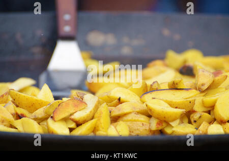 In a large frying pan prepares a large portion of fried potatoes. Stock Photo