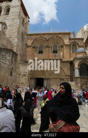 A muslim tourist stands in front of the Church of the Holy Sepulchre, Old City, Jerusalem. Stock Photo