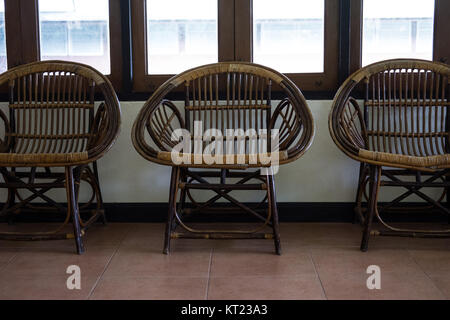 wicker rattan chair in living room beside window Stock Photo