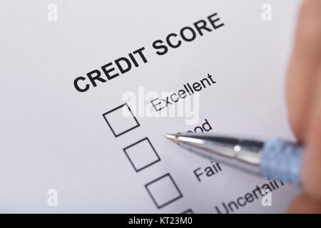 Person Filling Credit Score Form Stock Photo