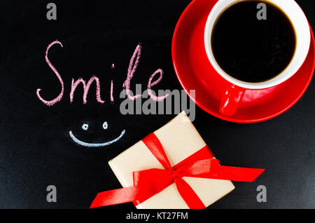 Cup of Coffee and Present. Inscription Smile. Stock Photo