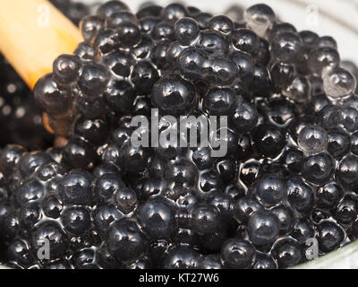 black caviar of halibut with spoon in glass jar Stock Photo