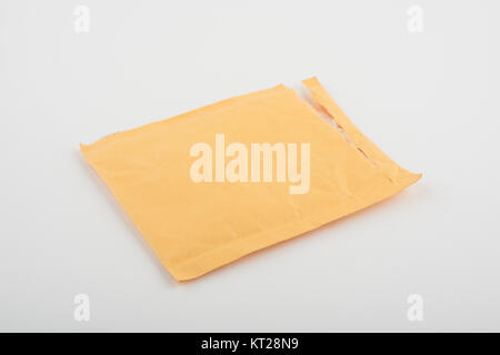 Open used yellow envelope isolated on white background Stock Photo