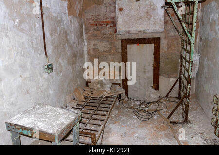 Typical cell with abandoned bed frames in the Eastern State Penitentiary Historic Site, Philadelphia, United States. Stock Photo