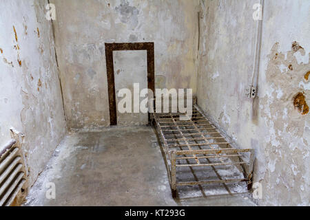 Typical cell with abandoned bed frame in the Eastern State Penitentiary Historic Site, Philadelphia, United States. Stock Photo