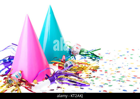 Two colorful birthday party hats with noisemakers and confetti on a white background Stock Photo