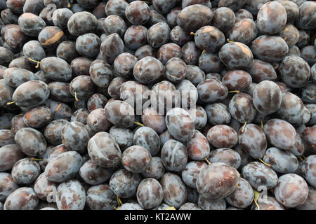 Fresh Red Plum Stack on Market Stall For Sale Stock Photo