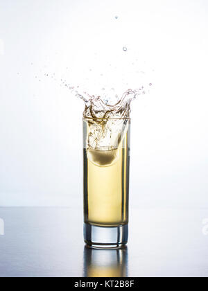 Yellow juice with splash in glass Stock Photo