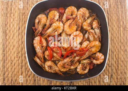 Cooked Fresh Shrimp with Tomato and Onions / Cooked Fresh Shrimp with Tomato and Onions Served in a plate on a Wooden ( Black Ceramic) background Stock Photo