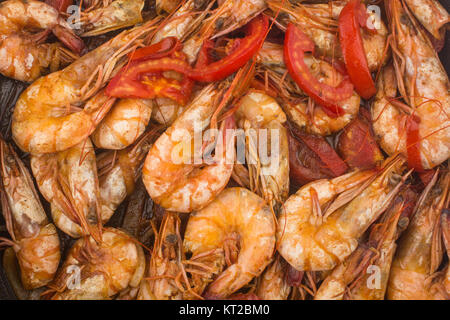 Cooked Fresh Shrimp with Tomato and Onions / Cooked Fresh Shrimp with Tomato and Onions Served in a plate on a Wooden ( Black Ceramic) background Stock Photo