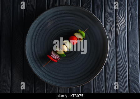 Grilled zuccini, bell pepper, mushroom, tomato and onion on skewer Stock Photo