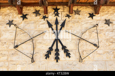 old stone wall with arrows and a bow Stock Photo