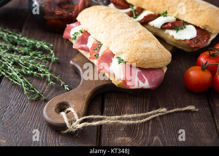 assorted sandwiches. sandwich Caprese with mozzarella and sun-dried tomatoes and ciabatta with ham Stock Photo