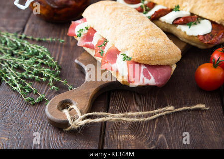 assorted sandwiches. sandwich Caprese with mozzarella and sun-dried tomatoes and ciabatta with ham Stock Photo