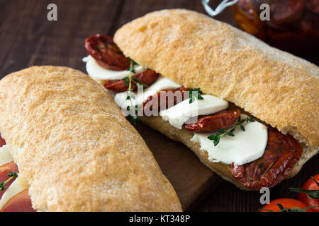 assorted sandwiches. sandwich Caprese with mozzarella and sun-dried tomatoes and ciabatta with ham Stock Photo