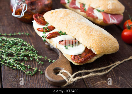 assorted sandwiches. sandwich Caprese with mozzarella and sun-dried tomatoes and ciabatta with ham Stock Photo