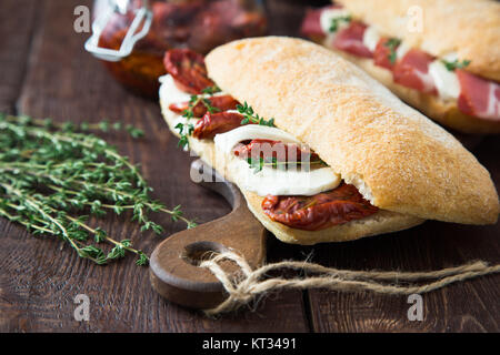 assorted sandwiches. sandwich Caprese with mozzarella and sun-dried tomatoes and ciabatta with ham Stock Photo