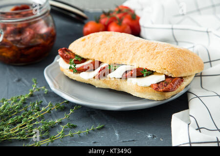 assorted sandwiches. sandwich Caprese with mozzarella and sun-dried tomatoes and ciabatta with ham Stock Photo