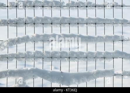 Snow on a wire fence in the Cotswolds. UK. Abstract pattern